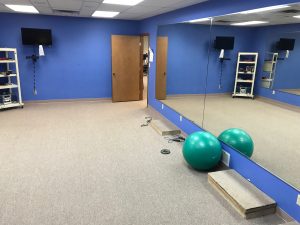 Blue fitness room with mirrors at Ultimate Image Fitness Centers